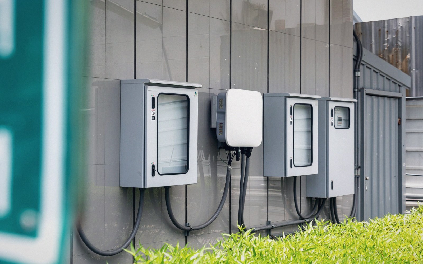 Electrical distribution boxes and a wall-mounted charger mounted on a building's exterior wall