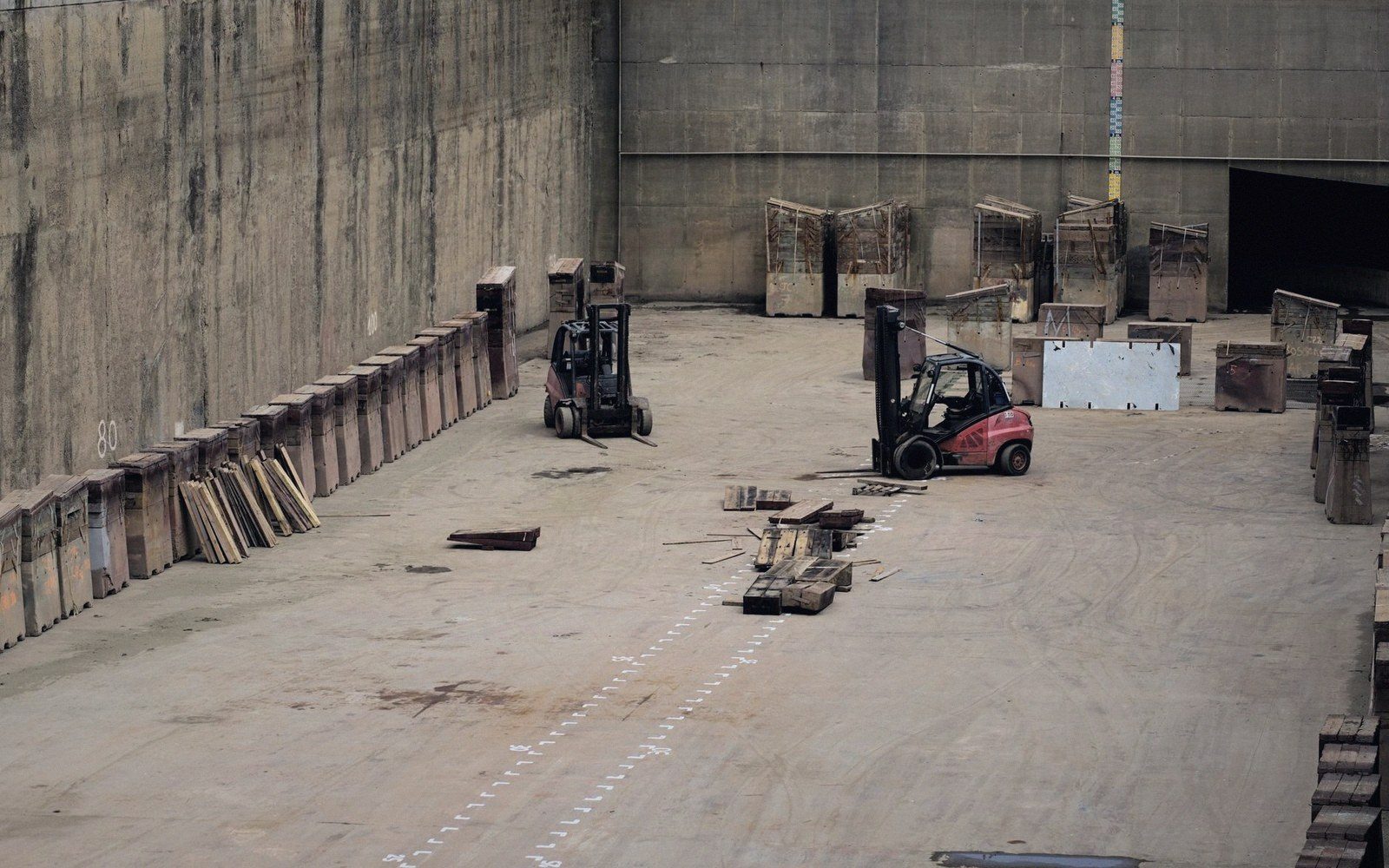 A forklift and pallets in a loading bay